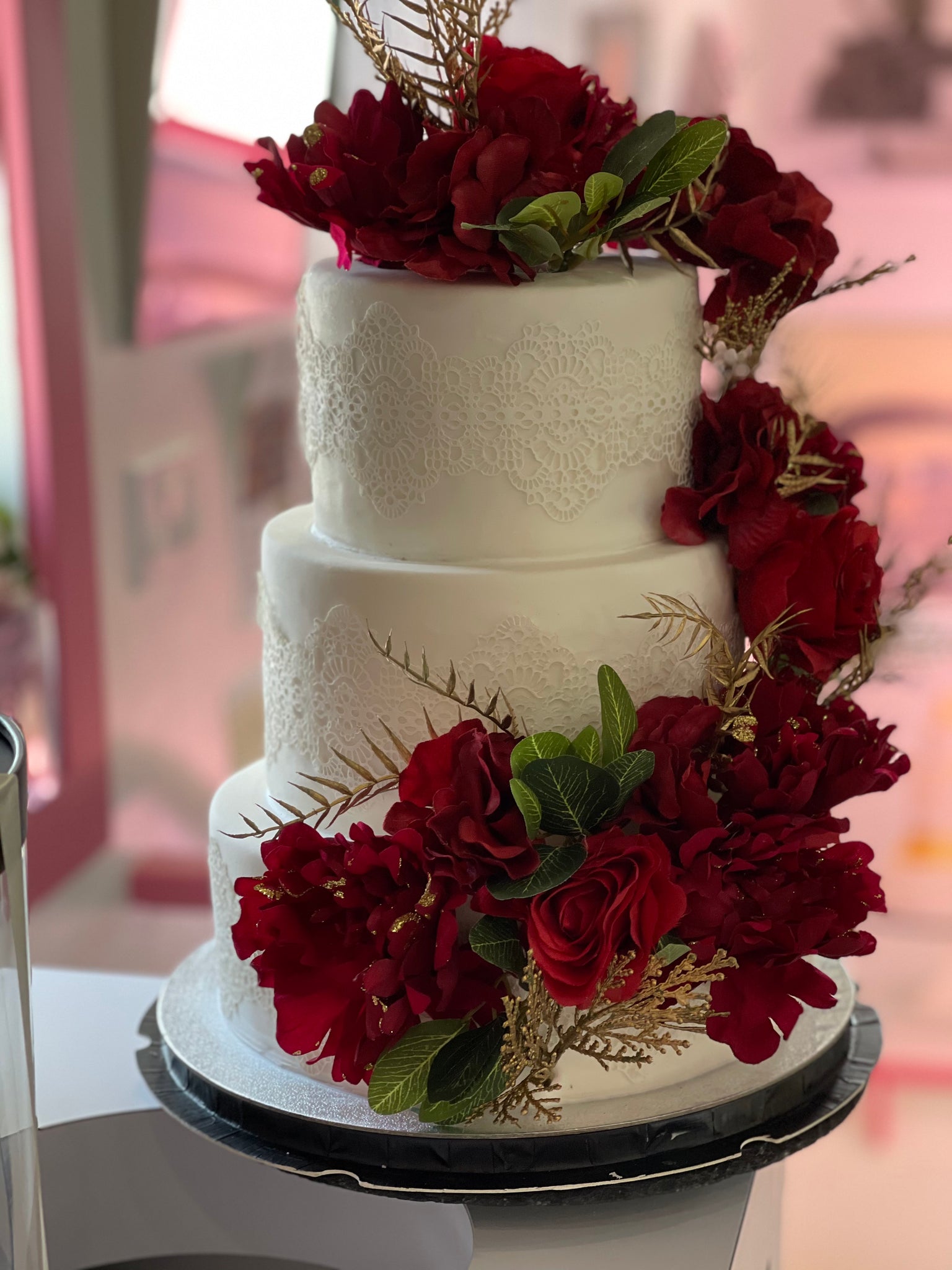 Tower Wedding Cake with Red Flowers Stock Photo - Alamy